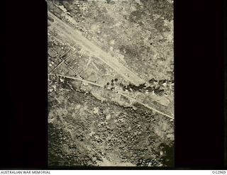 LAE, NEW GUINEA. 1942-09-19. AERIAL PHOTOGRAPH OF BOMBS EXPLODING ON THE AIRSTRIP DURING AN ATTACK BY ALLIED FORCES