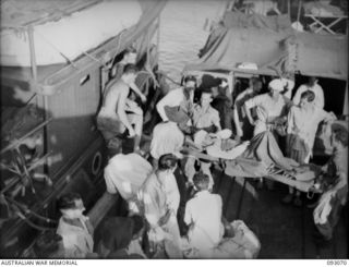 LALUM, BOUGAINVILLE, 1945-06-12. PATIENTS FROM 19 FIELD AMBULANCE DRESSING STATION BEING TRANSFERRED TO THE HOSPITAL SHIP STRADBROKE. THE MEN WERE WOUNDED DURING THE PORTON PLANTATION EVACUATION. ..