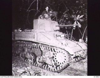 An M3 Stuart light tank moving up for the dawn attack