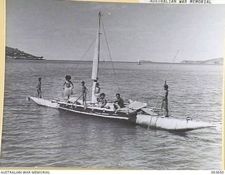 PORT MORESBY - NATIVE FAMILY AND THEIR DOMAIN - FAIRFAX HARBOUR. RAAF SURVEY FLIGHT. (NEGATIVE BY N. TRACY)