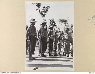 LAE AREA, NEW GUINEA, 1945-08-05. BRIGADIER P.S. MCGRATH, DEPUTY DIRECTOR OF SUPPLIES AND TRANSPORT (1) INSPECTING NO. 72 PLATOON, 151, GENERAL TRANSPORT COMPANY