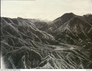 NEAR TOROKINA, BOUGAINVILLE ISLAND, SOLOMON ISLANDS. 1945-01-28. AERIAL VIEW OF THE FAMILIAR LANDMARK BY WHICH RAAF PILOTS MAY CHECK THEIR BEARINGS IS THE SMOULDERING ACTIVE VOLCANO MOUNT BAGANA. ..