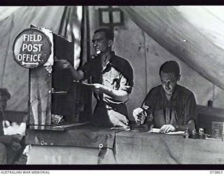 MADANG, NEW GUINEA. 1944-06-15. FIELD POST OFFICE 150 AT 15TH INFANTRY BRIGADE. LEFT TO RIGHT: V49951 PRIVATE R. E. FULLER AND VX135654 CORPORAL J. F. SHEAHAN