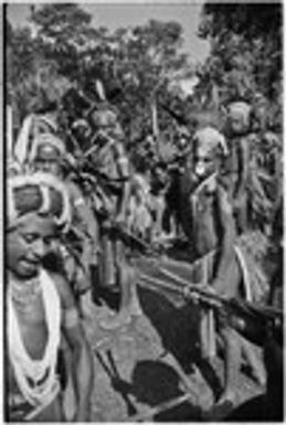 Pig festival, stake-planting, Tuguma: decorated Tsembaga men with ritual items to expel enemy spirits and establish boundary