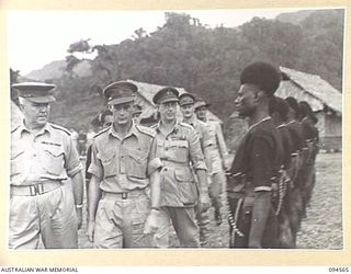 TOROKINA, BOUGAINVILLE, 1945-08-04. LIEUTENANT-GENERAL S.G. SAVIGE, GENERAL OFFICER COMMANDING 2 CORPS, INSPECTING THE GUARD OF HONOUR OF THE ROYAL PAPUAN CONSTABULARY. LIEUTENANT-GENERAL SAVIGE ..