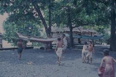 [Outrigger canoes and children on the shore in Safotu, Samoa]