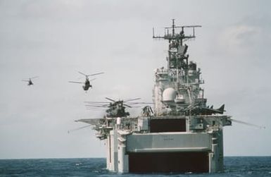 Two CH-46E Sea Knight helicopters of Marine Medium Helicopter Squadron 261 (HMM-261) depart the amphibious assault ship USS SAIPAN (LHA 2) during Operation Sharp Edge. Marines of the 22nd Marine Expeditionary Unit (22nd MEU) are being sent to the U.S. Embassy in Monrovia, Liberia, to augment security and evacuate U.S. and foreign nationals from the fighting between government and rebel forces