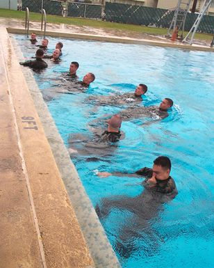 USMC personnel assigned to Headquarters Battalion, Marine Corp Base Hawaii, Kaneohe Bay go through their annual swim qualification at the base swimming pool