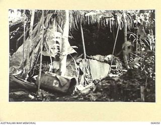 GOALING RIVER, NEW GUINEA. 1944-01-21. A JAPANESE REGIMENTAL AID POST, STOCKED WITH MEDICAL STORES AND GEAR AND SHELTERING UNDER AN OVERHANGING LIMESTONE CLIFF FACE, WHICH WAS HASTILY EVACUATED ..