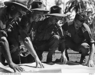 AITAPE, NEW GUINEA. 1945-01-08. NX1137 SERGEANT C.P. HOOPER (LEFT), NX122890 CAPTAIN A.J. MARSHALL, OFFICER- IN- CHARGE (SECOND LEFT) AND VX22598 LIEUTENANT P. C. BEENIE (THIRD LEFT) OF THE 2/2ND ..