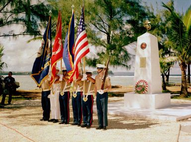 A joint Marine Corps/Navy color guard stands at attention at the Congressional Medal of Honor Monument dedication ceremony. The monument honors four Marines for heroism during World War II. They are Captain Louis Wilson, Jr., Private First Class (PFC) Leonard Mason, PFC Luther Skaggs and PFC Frank Witek