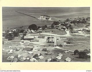 PORT MORESBY, NEW GUINEA. 1944-06-27. A GENERAL VIEW OF THE 1ST BULK PETROLEUM STORAGE COMPANY SHOWING THE CAMP (FOREGROUND), DRUM RUMBLING SHED (LEFT MIDDLE DISTANCE "Q" STORE AND WORKSHOPS ..