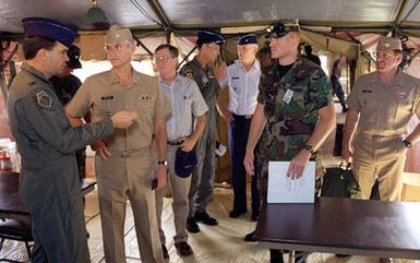 US Air Force Colonel (COL) John M. Deloney (far left), 36th Air Base Wing Commander, and US NAVY Admiral (ADM) Joseph W. Prueher, Commander in CHIEF U.S. Pacific Command, talk while touring a hospital at Andersen Air Force Base, Guam, during OPERATION PACIFIC HAVEN. Members of ADM Pruehers staff and other Commanders of Operation Pacific Haven look on. Pacific Haven, a joint humanitarian operation conducted by the U.S. Military, evacuated over 2,100 Kurds from Northern Iraq. The evacuees will be housed temporarily at Andersen AFB, Guam, while they go through the immigration process for residence into the United States