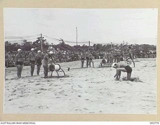 TOROKINA, BOUGAINVILLE, 1945-07-08. BELT MAN GETTING READY FOR THE RESCUE AND RESUSCITATION DISPLAY AT THE CHAMPIONSHIP SURF CARNIVAL HELD BY SOLOMON ISLAND SURF LIFE SAVING CLUB AND CONDUCTED BY ..