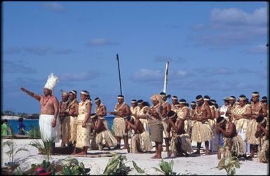 Men in traditional dress on beach