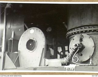 17 MILE, PORT MORESBY AREA, NEW GUINEA. 1943-12-04. BASE OF THE BOILER AND THE FURNACE HEATER WHICH SUPPLIES THE HOT WATER FOR THE 9TH AUSTRALIAN DIVISION MOBILE LAUNDRY