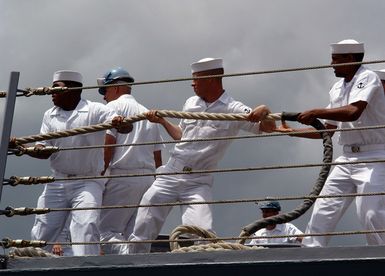 Onboard the US Navy (USN) Oliver Hazard Perry Class Guided Missile Frigate, USS CROMMELIN (FFG 37), USN Sailors heave too on the mooring line as the ship prepares to get underway at Naval Base Pearl Harbor Hawaii (HI). The CROMMELIN will travel to various locations in the Western Pacific to take part in the Cooperation Afloat Readiness and Training (CARAT) 2006 Exercise