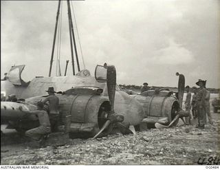 KIRIWINA, TROBRIAND ISLANDS, PAPUA. C. 1944-02-04. GROUND CREW LOOKING OVER A CRASH-LANDED BEAUFIGHTER AIRCRAFT OF NO. 30 SQUADRON RAAF TO SEE HOW LONG IT WILL TAKE TO GET IT IN THE AIR AGAIN. NOTE ..
