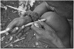 Carving: stone tool being used to smooth an arrow