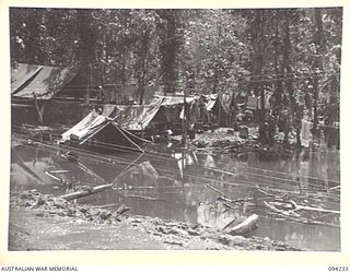 SOUTH BOUGAINVILLE. 1945-07-21. THE FLOODED CAMP SITE OF 58/59 INFANTRY BATTALION, WEST OF THE OGORATA RIVER. OPERATIONS HAVE BEEN DELAYED OWING TO THE BUIN ROAD, OUR MAIN SUPPLY ROUTE, BECOMING ..