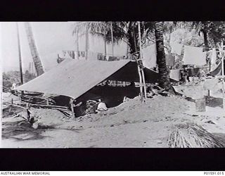 MARKHAM VALLEY, NEW GUINEA. C.1945. EXTERIOR VIEW OF THE TENT AND SURROUNDING CAMP OF SERGEANT N. (NAT) F. DANIELL WHERE HE MONITORED RADIO BROADCASTS FOR THE MOBILE PROPAGANDA UNIT, FAR EASTERN ..