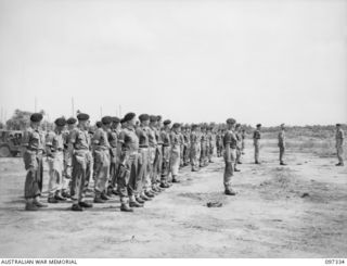 RAPOPO AIRSTRIP, NEW BRITAIN. 1945-09-28. AUSTRALIAN TANK CREWS OF 2/4 ARMOURED REGIMENT ON PARADE AT THE AIRSTRIP BEFORE THE TAKE OVER OF TANKS SURRENDERED BY THE JAPANESE AT THE AIRSTRIP. A TOTAL ..