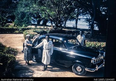 Mother of Allan Flinders Gow and two Papua New Guineans beside car