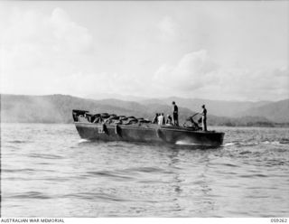 MALASIGE, NEW GUINEA, 1943-10-23. AN AMERICAN BARGE TAKING THE AUSTRALIAN AND NEW GUINEA ADMINISTRATIVE UNIT PARTY FROM MALASIGE TO TAMI ISLAND