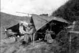 Soldier sitting in small tent, Guadalcanal, 1940s