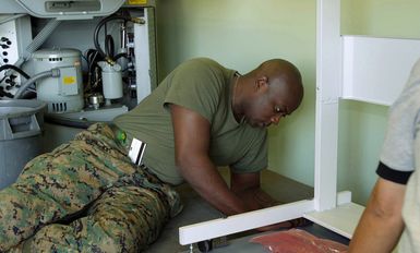US Marine Corps (USMC) Corporal (CPL) Irick Scott helps to install a Xerox machine for the G-3 Combat Camera and Printing Center at Marine Forces Pacific (MARFORPAC) at Camp H.M. Smith, Hawaii (HI), during Operation IRAQI FREEDOM