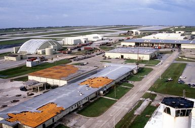 Hangars and other buildings display the effects of Typhoon Omar, which hit the area on August 29th, causing severe damage to Andersen; Naval Station, Guam; and the surrounding area