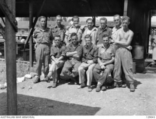 LAE, NEW GUINEA. 1945-12. MEMBERS OF 4TH ADVANCED ORDNANCE DEPOT. LEFT TO RIGHT, FRONT ROW: N249300 PRIVATE (PTE) N. C. HURST; QX47974 PTE T. A. HINCKS; PTE MADDISON; S39417 PTE E. R. WOODLANDS; ..