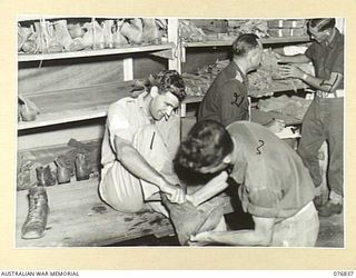 LAE, NEW GUINEA. 1944-11-11. PATIENTS BEING ISSUED WITH CLOTHING AT THE "Q" STORE OF THE 112TH CONVALESCENT DEPOT. IDENTIFIED PERSONNEL ARE: SERGEANT W. GREER (1), CORPORAL H.J. BANNENBERG (2), ..