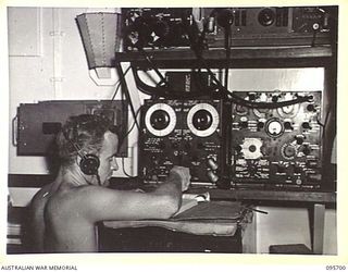 AT SEA OFF RABAUL, NEW BRITAIN. 1945-09-04. LEADING TELEGRAPHIST W.G. MCCARTNEY, HMAS VENDETTA, CONTACTING RABAUL BY RADIO AS THE SHIP PROCEEDS TO A SEA RENDEZVOUS WITH REPRESENTATIVES OF GENERAL ..