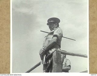 KILA, NEW GUINEA, 1943-10-24. MAJOR-GENERAL B.M. MORRIS DSO., GENERAL OFFICER COMMANDING, AUSTRALIAN AND NEW GUINEA ADMINISTRATIVE UNIT ADDRESSING NATIVES AT THE NATIVE LABOUR CAMP. NOTE THE CANE ..