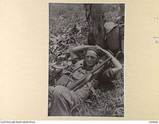 ILIPEM, NEW GUINEA, 1945-07-31. CORPORAL J. PANNOWITZ, B COMPANY, 2/5TH INFANTRY BATTALION, WAITING TO MOVE FORWARD TO A NEW POSITION, DURING PREPARATIONS FOR THE BIG MOVE FORWARD TO CRACK JAPANESE ..