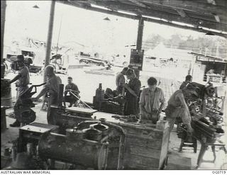 NADZAB, NEW GUINEA. C. 1944-02. PERSONNEL OF NO. 62 MOBILE WORKS SQUADRON RAAF IN AN OPEN AIR MOBILE WORKS WORKSHOP AT AN ADVANCED NEW GUINEA BASE