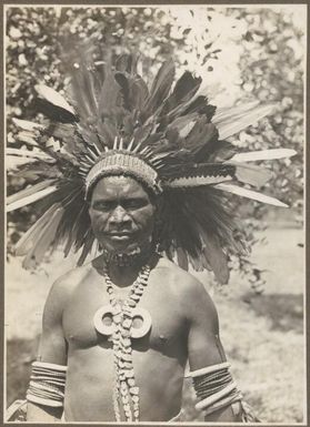 Buna Bay District [man in feathered head dress] Frank Hurley