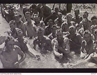 NADZAB AIRSTRIP, NEW GUINEA. 1943-09-19. TROOPS OF THE 2/5TH AUSTRALIAN FIELD COMPANY ATTACHED TO THE 25TH AUSTRALIAN INFANTRY BRIGADE ENJOY A WASH IN THE CREEK AFTER THEIR TWENTY FIVE MILE MARCH ..