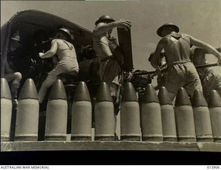 Pacific Area. c. 1942. A row of anti aircraft shells ready to be loaded into the gun in the background