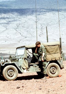 Through radio coordination, forward air control team member Captain Charles Westenoff directs an F-16 Fighting Falcon aircraft to a target area for a strike during exercise COPE ELITE '81. The control team is from the 22nd Tactical Air Support Squadron