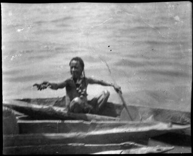 Woman in a canoe offering a crab, Ramu River, New Guinea, 1935 / Sarah Chinnery