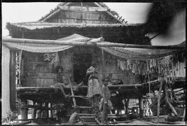 Group of people outside the front of a gabled house, New Guinea, ca. 1929 / Sarah Chinnery