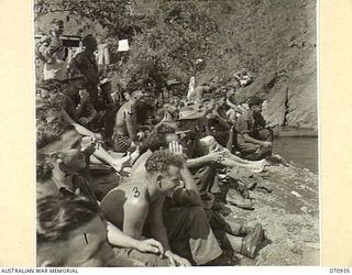 ZENAG, NEW GUINEA, 1944-02-27. SPECTATORS AT A SPORTS CARNIVAL HELD IN A CREEK DAMMED BY MEMBERS OF THE 2/9TH FIELD COMPANY, ROYAL AUSTRALIAN ENGINEERS. THE CARNIVAL, ASTTENDED BY VISITORS FROM ..