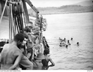 JACQUINOT BAY, NEW BRITAIN. 1944-11-06. TROOPS OF B COMPANY 1ST NEW GUINEA INFANTRY BATTALION HAULING THEIR LAKATOIS ABOARD THE MOTORSHIP FRANCES PEAT, A FORMER HAWKESBURY RIVER VEHICULAR FERRY, ..