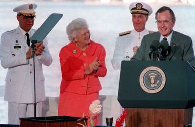General Colin L. Powell, left, Chairman of the Joint Chiefs of STAFF, first lady Barbara Bush and Admiral Charles R. Larson, Commander in CHIEF, US Pacific Command, applaud as President George Bush finishes a speech on Kilo 8 Pier during the observance of the 50th anniversary of the Japanese attack on Pearl Harbor