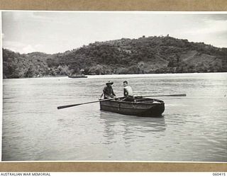 GODOWA, NEW GUINEA. 1943-11-05. NX53715 GUNNER A. C. COLE OF WARREN, NSW (LEFT), AND VX18845 SERGEANT J. W. PHILIP OF FOOTSCRAY, VIC (RIGHT), BOTH OF THE 11TH BATTERY, 2/3RD AUSTRALIAN TANK ATTACK ..