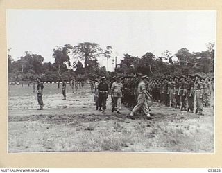 TOROKINA, BOUGAINVILLE, 1945-07-11. LIEUTENANT-GENERAL S.G. SAVIGE, GENERAL OFFICER COMMANDING 2 CORPS (1) ACCOMPANIED BY SENIOR OFFICERS, INSPECTING A COMPOSITE COMPANY, COMPRISING WORKSHOP, FIELD ..