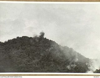 FARIA RIVER, NEW GUINEA. 1944-01-20. SMOKE RISING FROM JAPANESE POSITIONS ACROSS MAIN CREEK, AFTER A STRIKE BY ALLIED MITCHELL BOMBERS