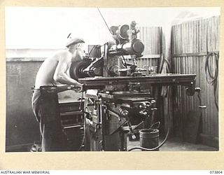 LAE, NEW GUINEA. 1944-06-09. SX4572 CORPORAL DOBSON, 2/7TH ADVANCED WORKSHOP (1), OPERATES A MILLING MACHINE IN THE UNIT'S MACHINE SHOP